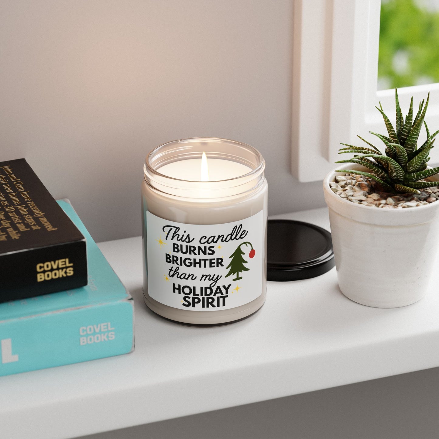 Candle with a humorous label on a shelf with books and a plant