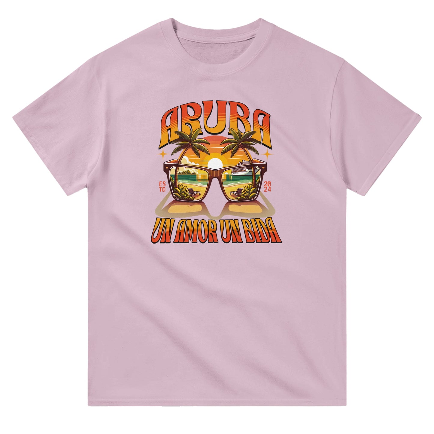 Pink unisex crewneck T-shirt with “Aruba – Un Amor, Un Bida” graphic, palm trees, and sunset island design.