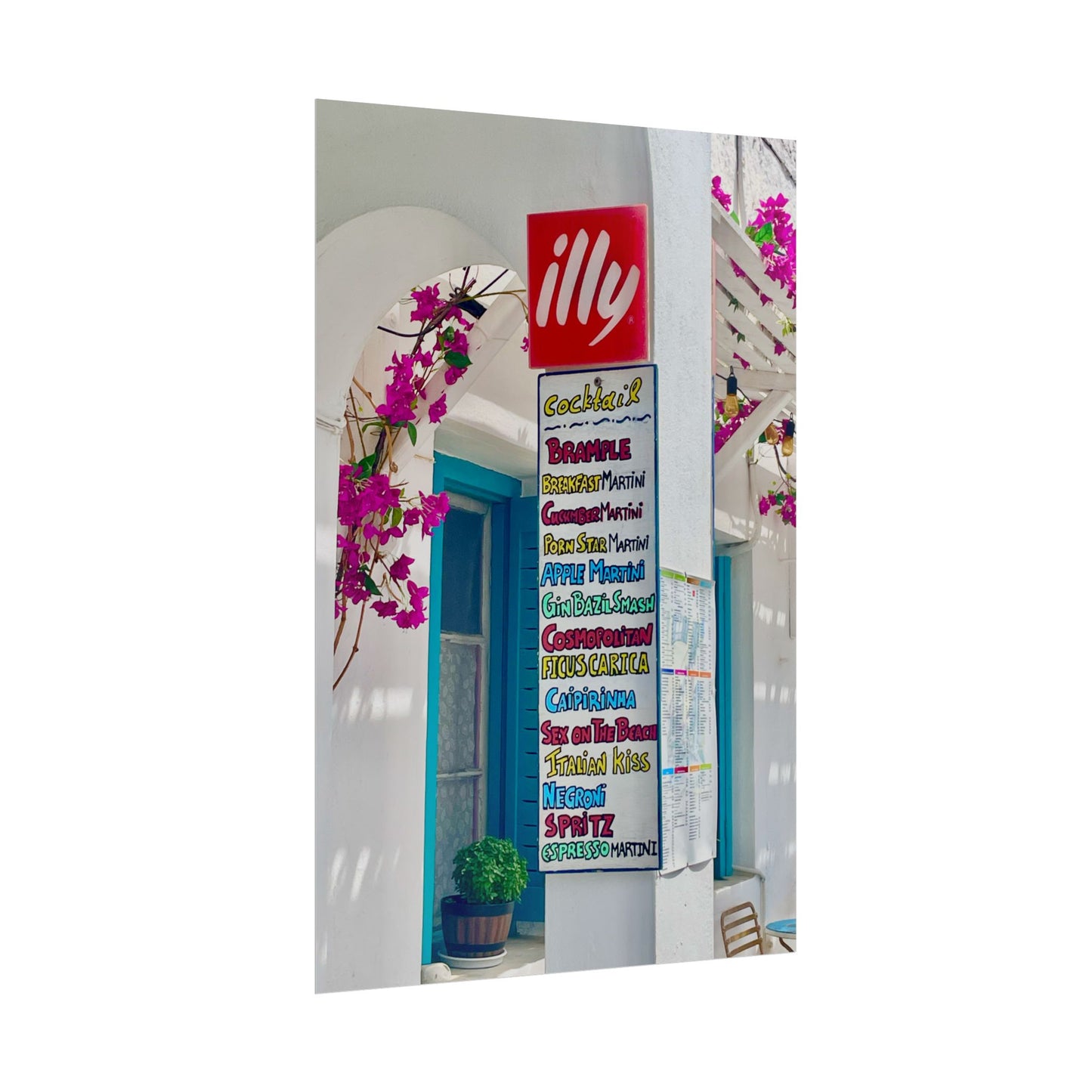 Decorative mirror with colorful text and floral design, featuring the illy logo.