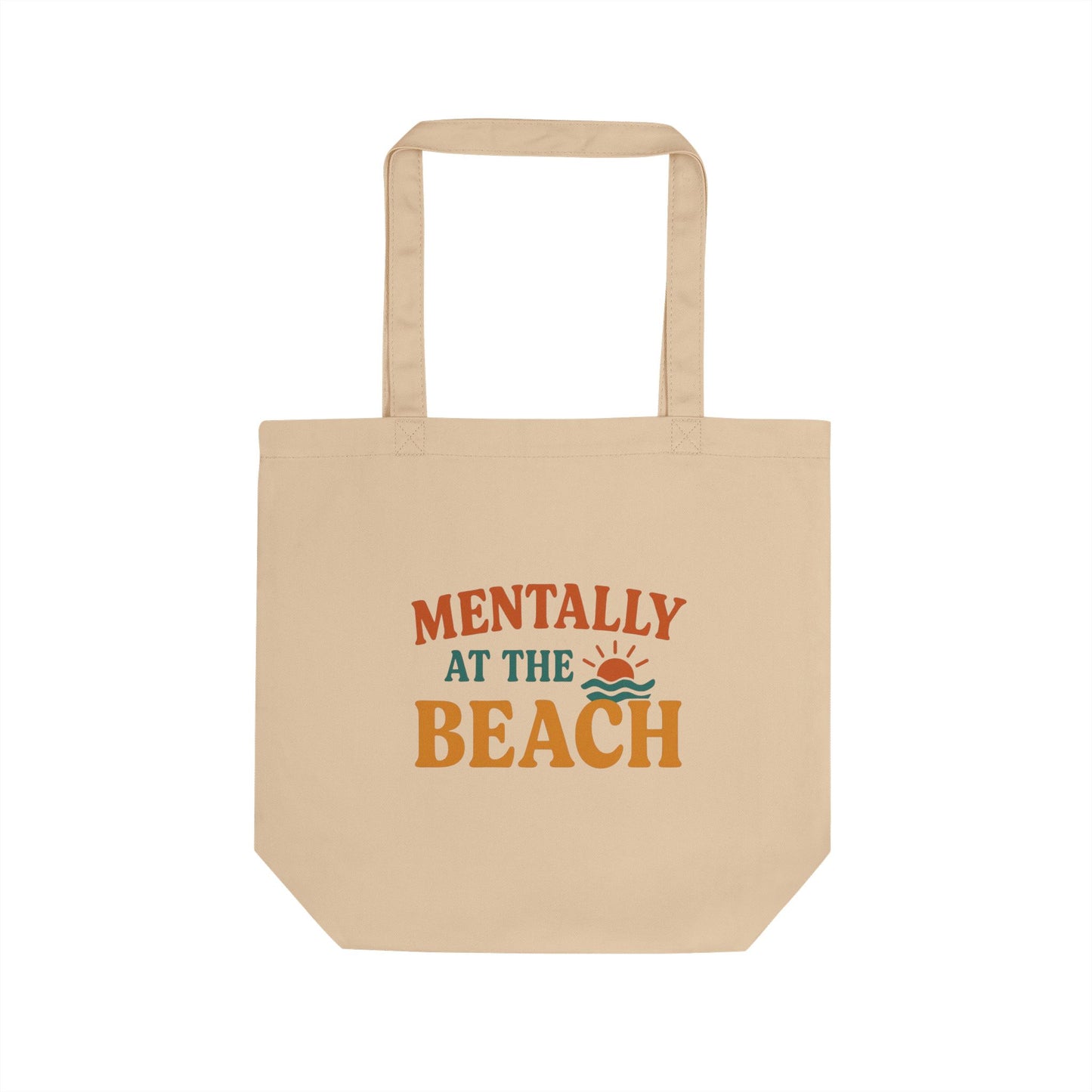 Beige tote bag with 'Mentally at the Beach' text and graphics on a white background