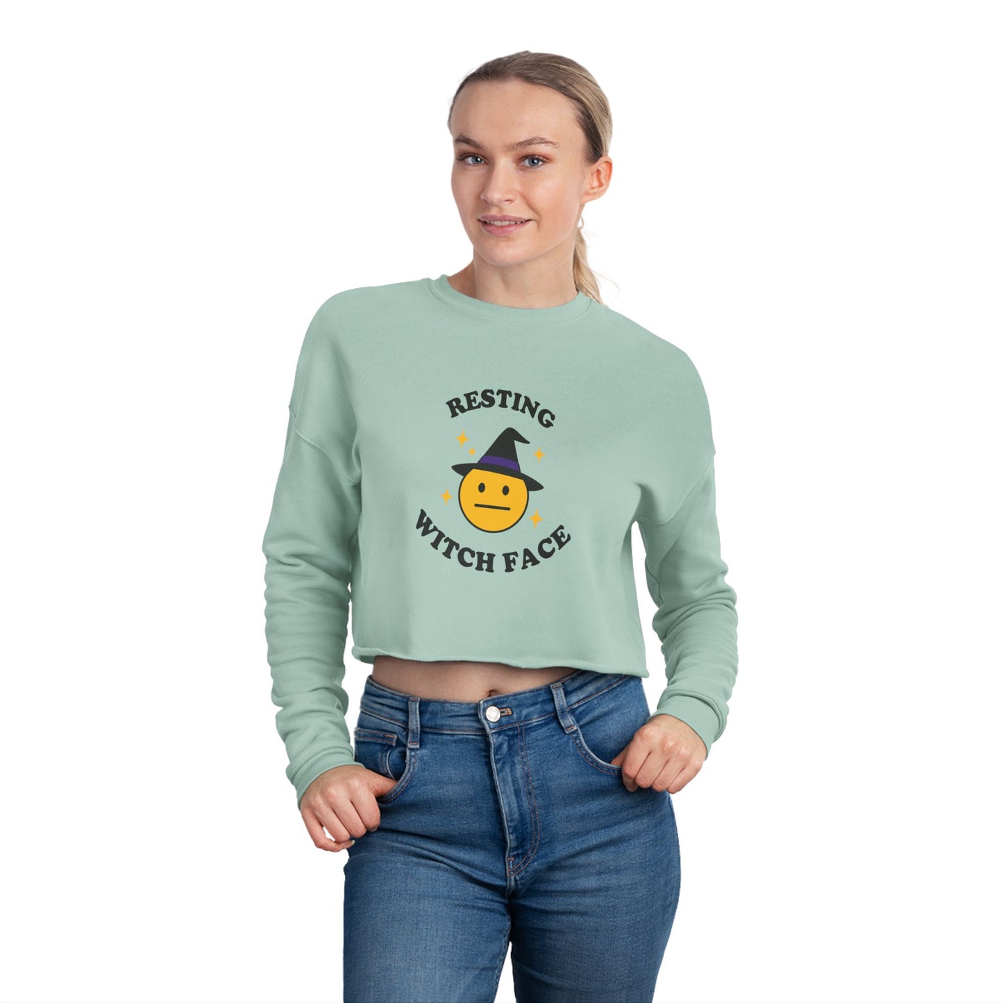 Person wearing a light green sweatshirt with 'Resting Witch Face' design on a white background