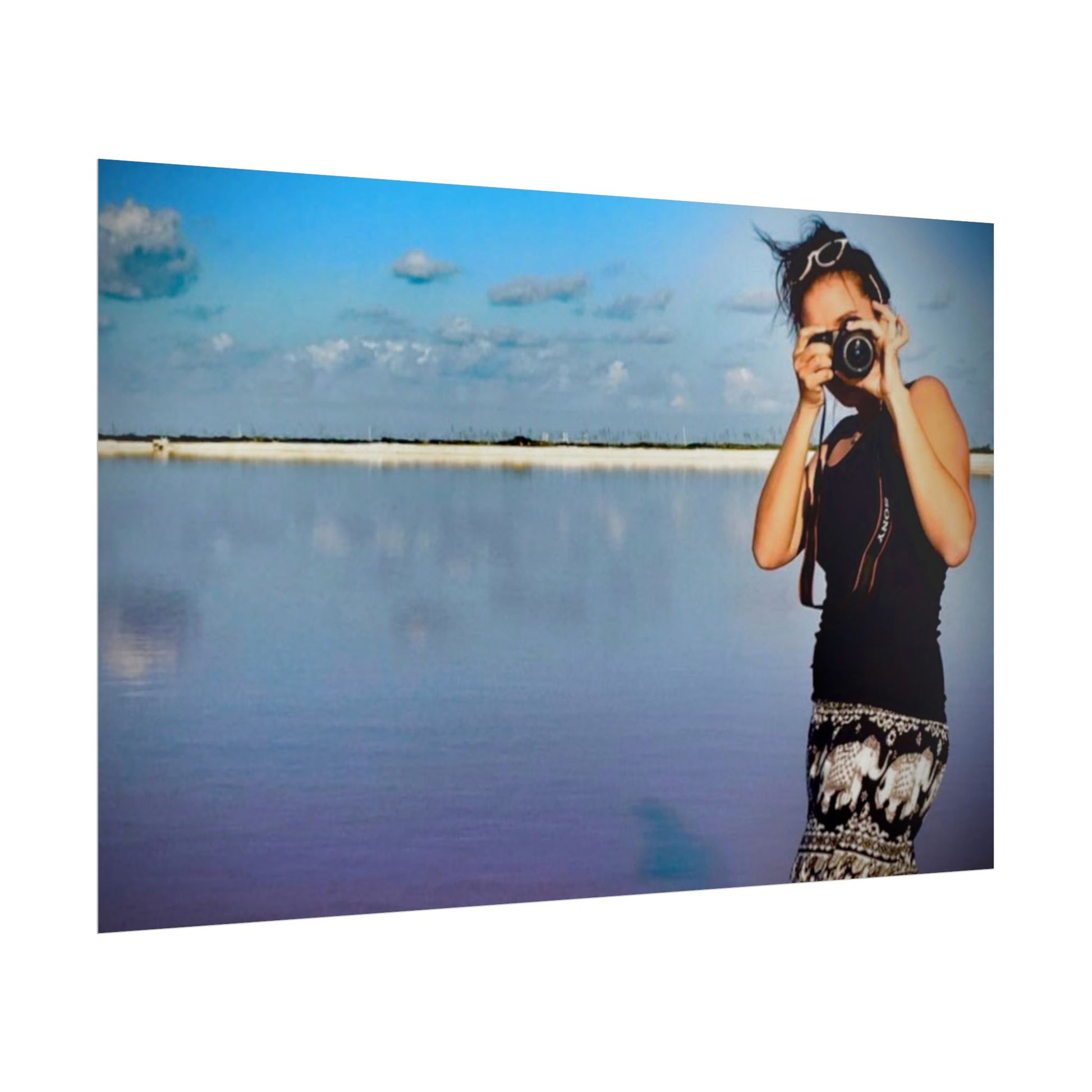 Woman taking a photo of a scenic landscape with a camera.