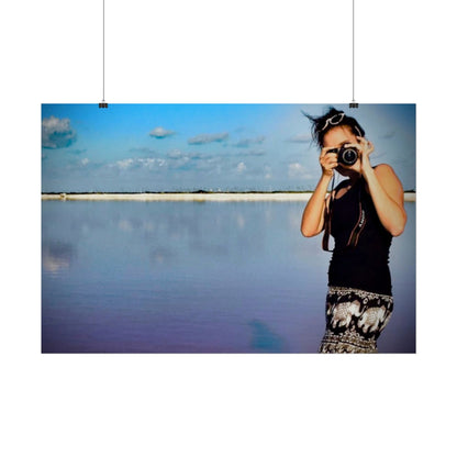 Person taking a photo of a scenic view with a camera.