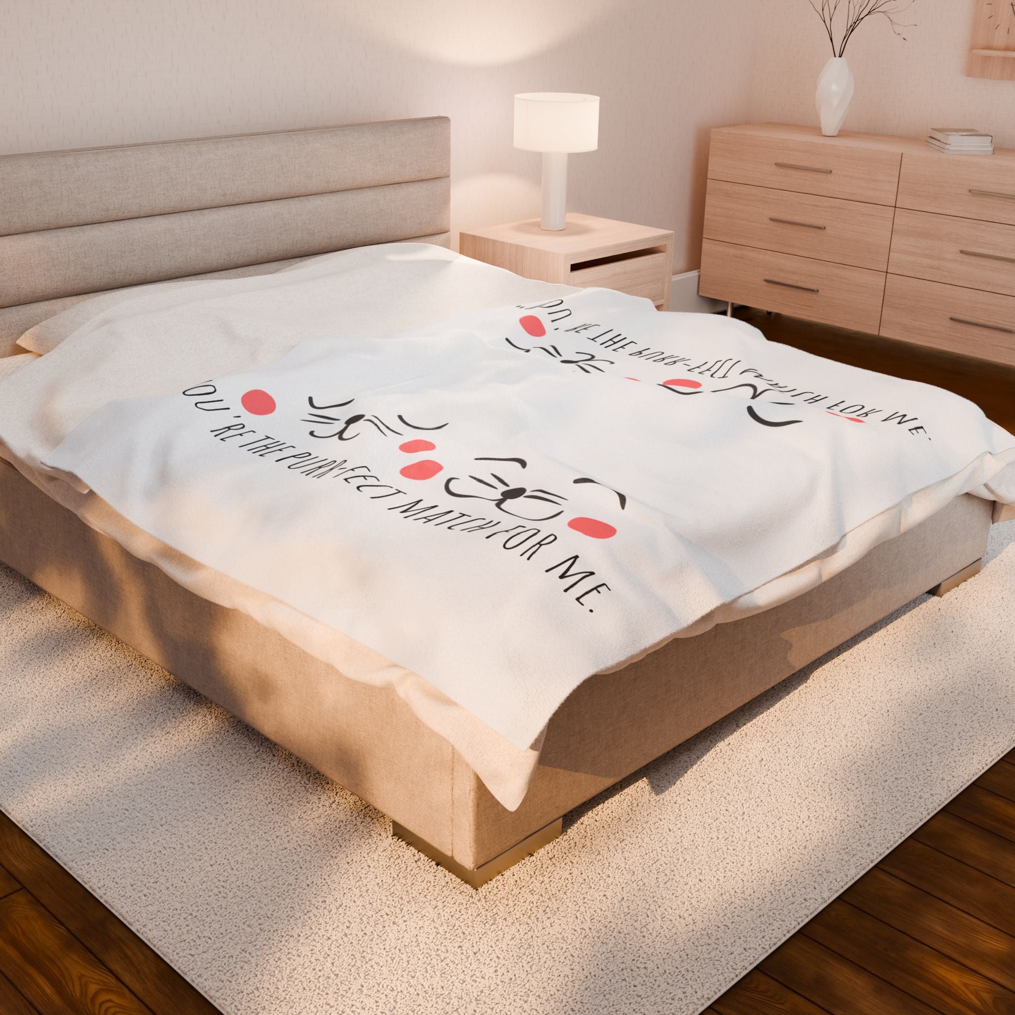 White cat-face plush blanket on a bed in a modern bedroom