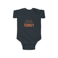 Navy blue baby onesie with 'Little Turkey' text on a white background