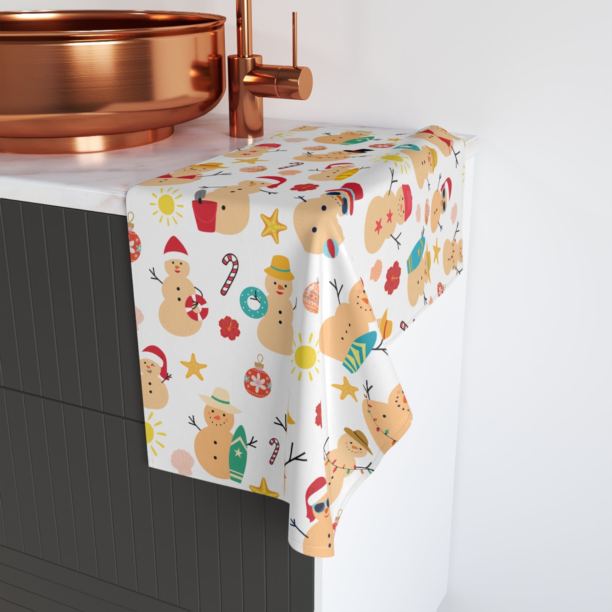Ceramic sink with a decorative towel featuring Christmas-themed designs on a white background.