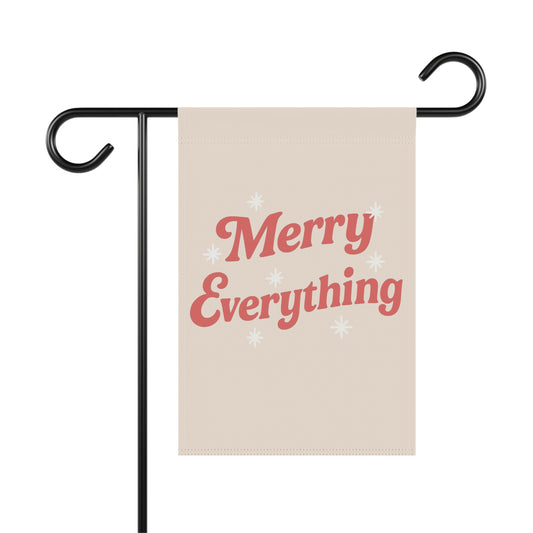 Beige garden flag with 'Merry Everything' text on a black stand against a white background