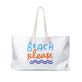 White canvas weekender tote with rope handles and 'Beach Please' text in blue and orange above a wave, on a white background