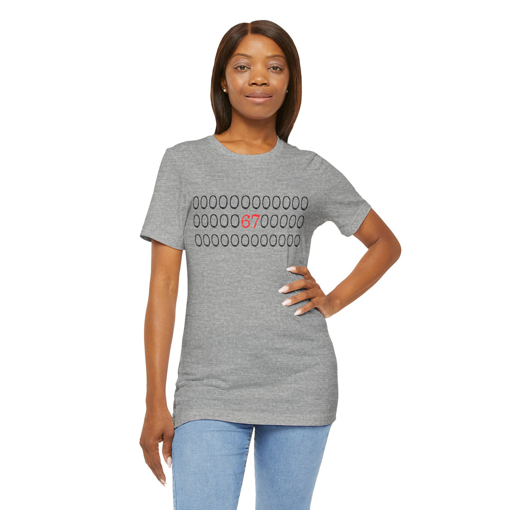 Athletic heather gray t-shirt with rows of circles and a red '67' graphic, worn by a woman with jeans