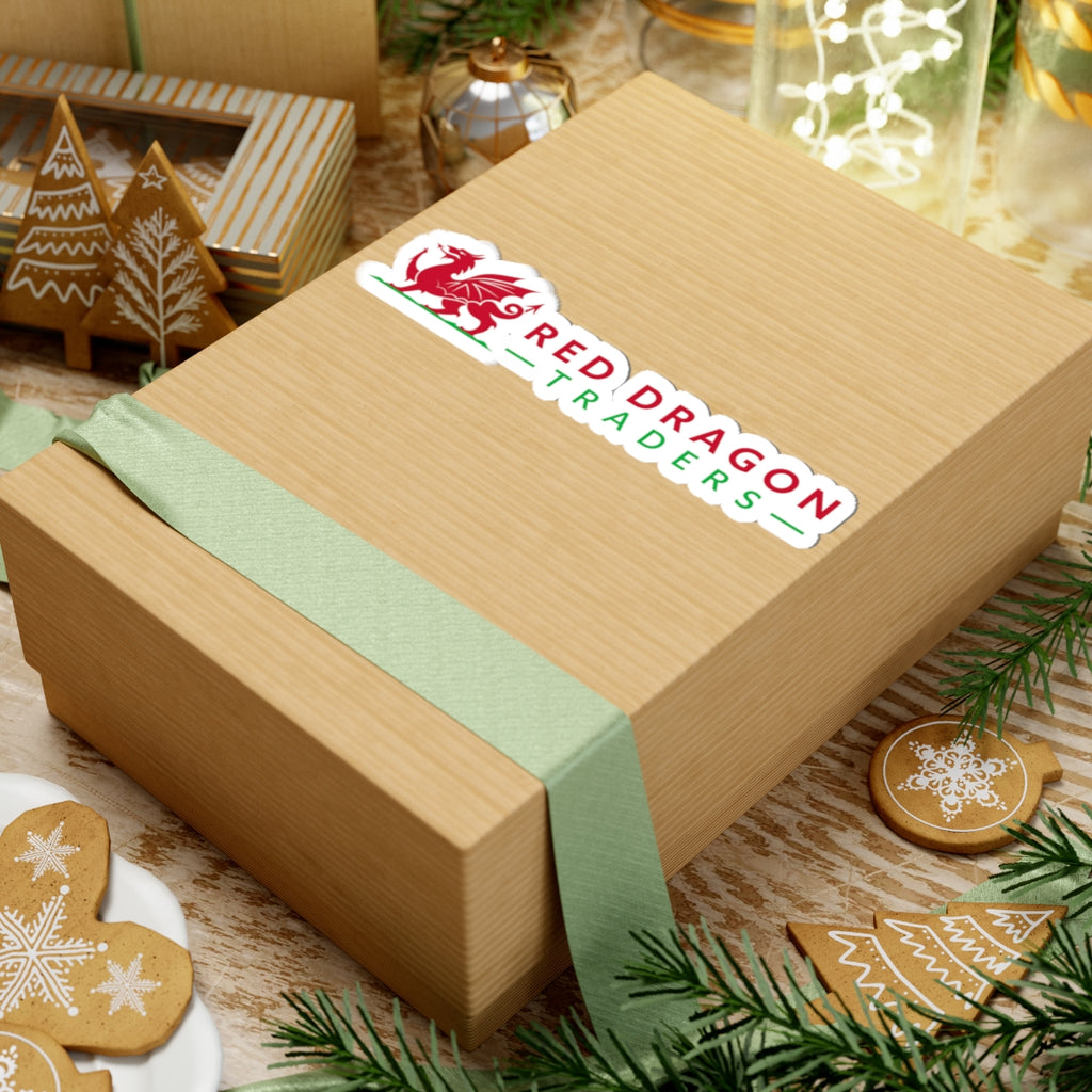 Wooden gift box with a green ribbon and 'Red Dragon Traders' logo on a festive background with cookies and decorations.