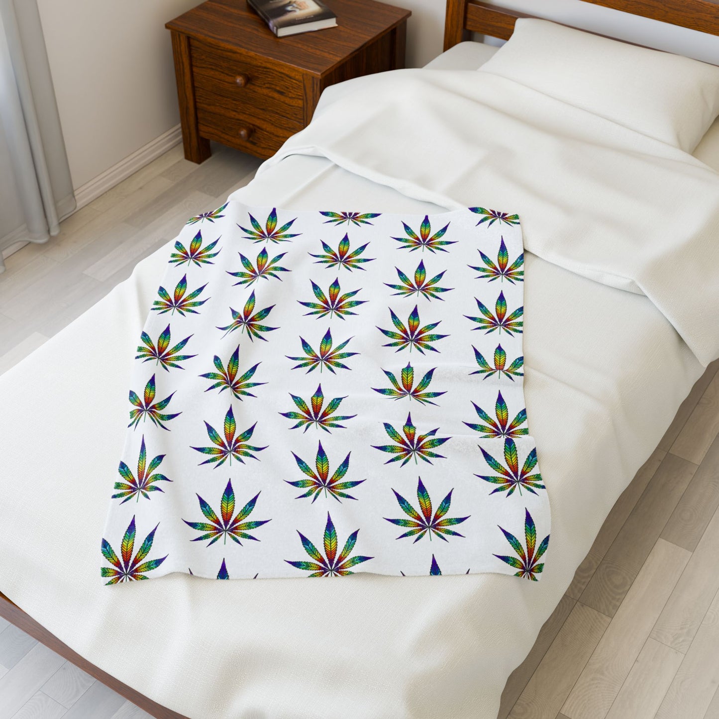 Cannabis Leaf Blanket with rainbow patterns in small on bed
