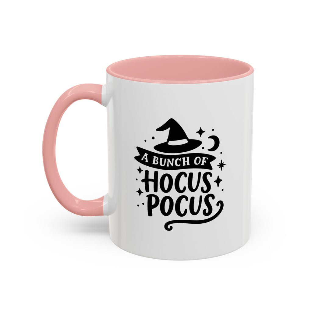 White two-tone coffee mug with a pink handle and interior and a black 'A Bunch of Hocus Pocus' witch-hat design, on a white background