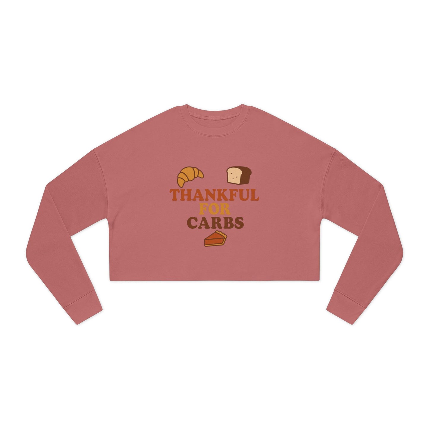 Pink long-sleeve crop top with 'Thankful for Carbs' text and food graphics on a white background