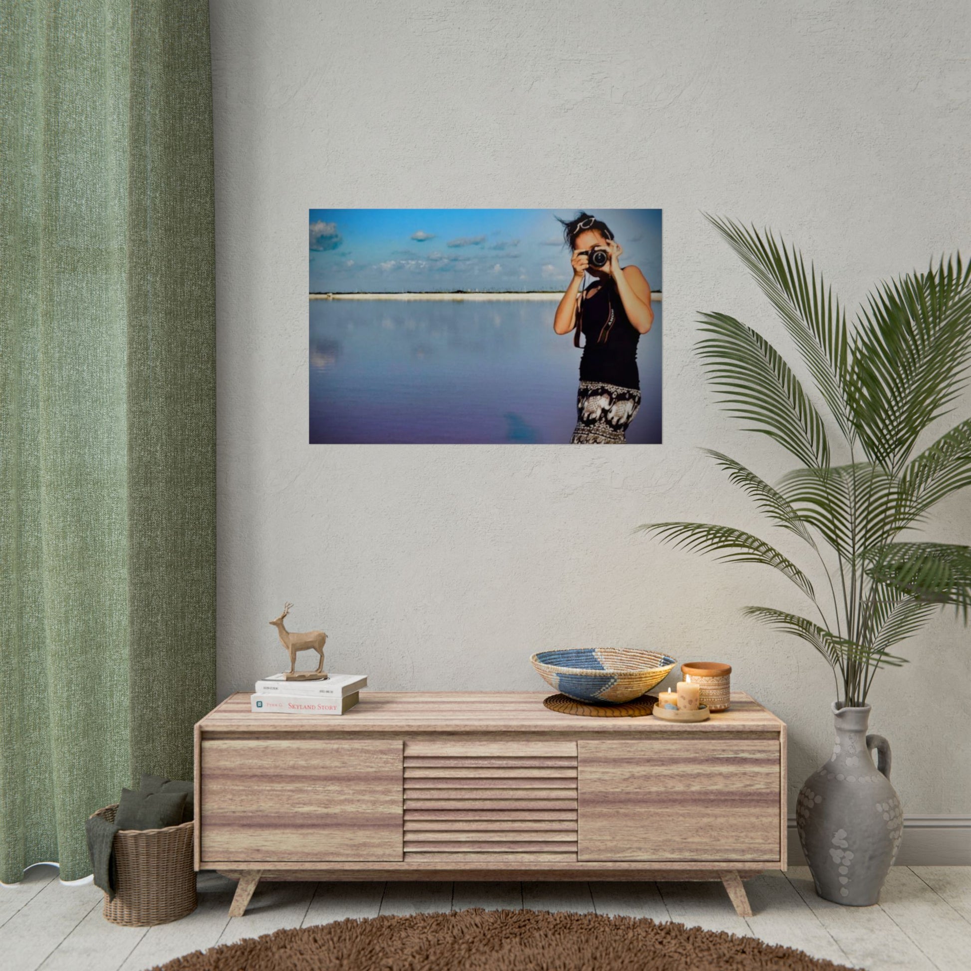 Living room with wooden cabinet, decorative items, and a framed photo on the wall.