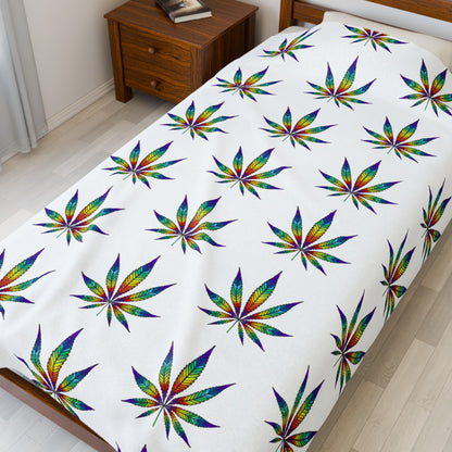 Cannabis Leaf Blanket with rainbow patterns on small bed 