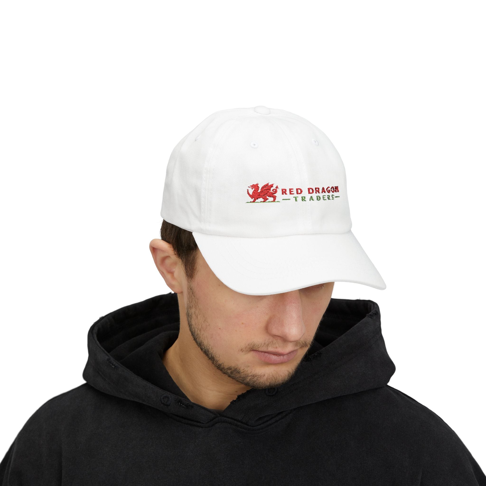 Person wearing a white cap with a red dragon logo on a white background