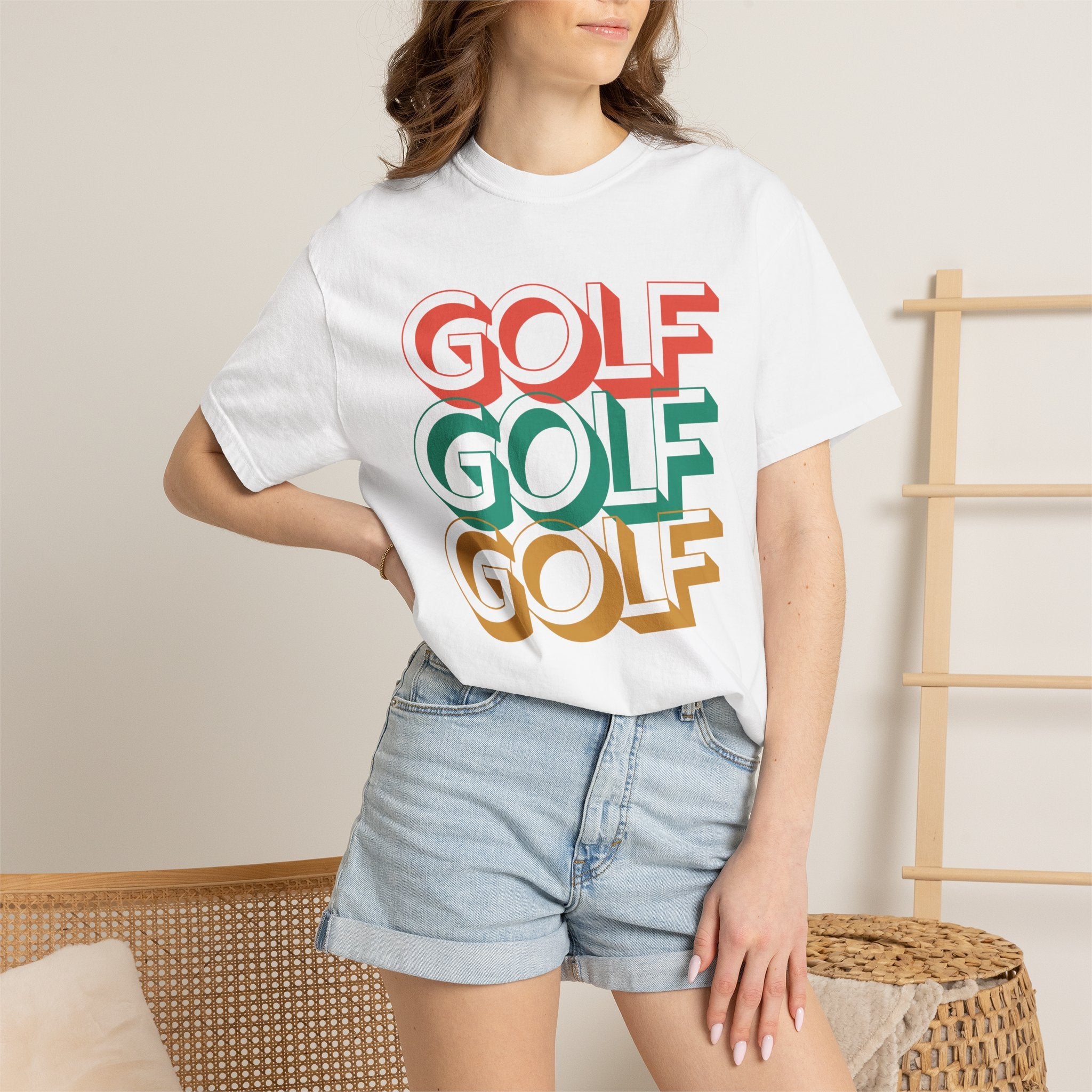 Person wearing a white t-shirt with 'GOLF GOLF GOLF' text in red, green, and yellow.