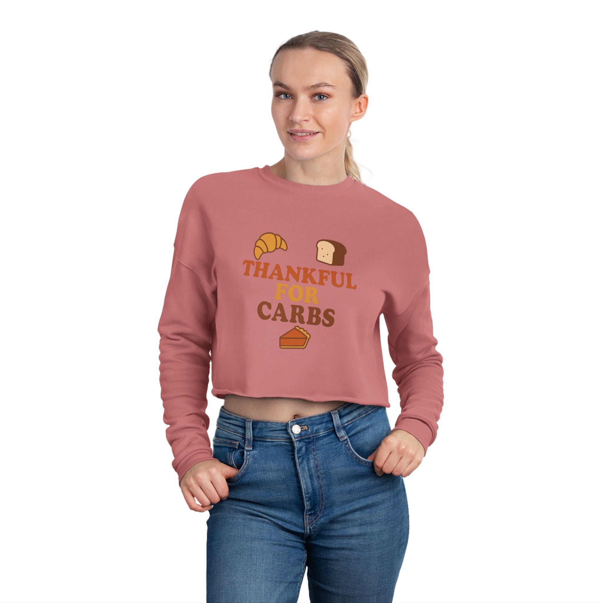 Person wearing a pink sweatshirt with 'Thankful for Carbs' text and food graphics on a white background