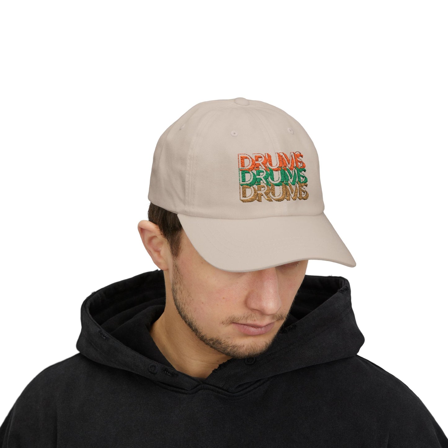 Man wearing a beige cap with colorful text on a white background