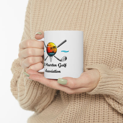Person holding a white mug with a golf-themed design and text.