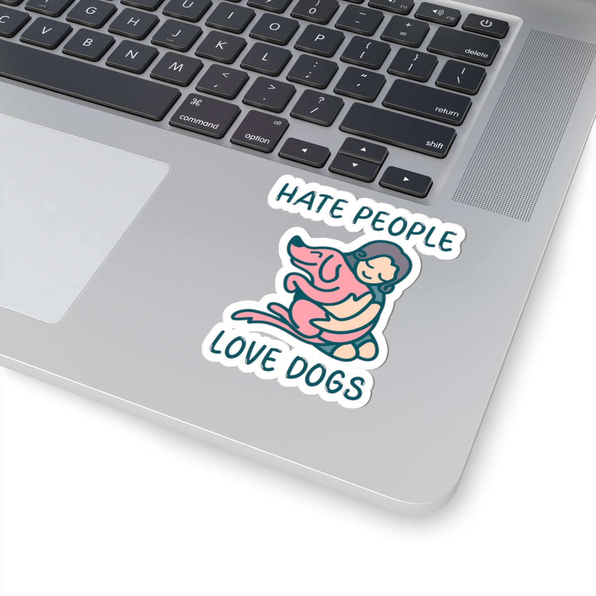 Laptop with a sticker that says 'Hate people love dogs' on the palm rest area.
