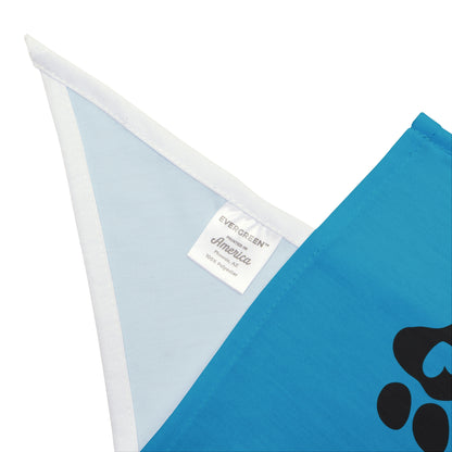 Blue bandana with a black paw print and a white triangle on a light blue background, featuring a brand label.