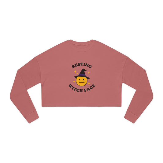 Pink long-sleeve crop top with 'Resting Witch Face' design on a white background