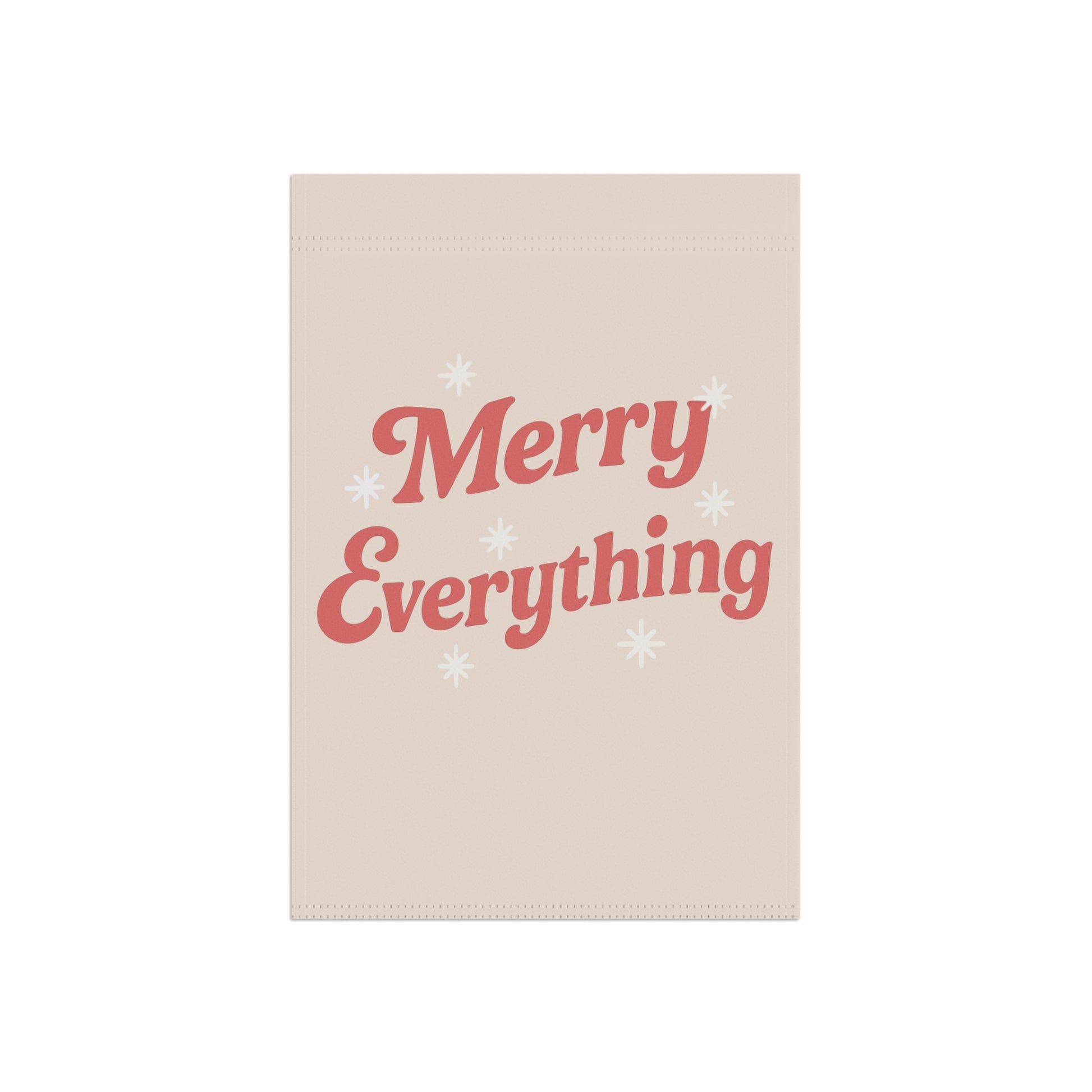Beige towel with 'Merry Everything' text in red on a white background