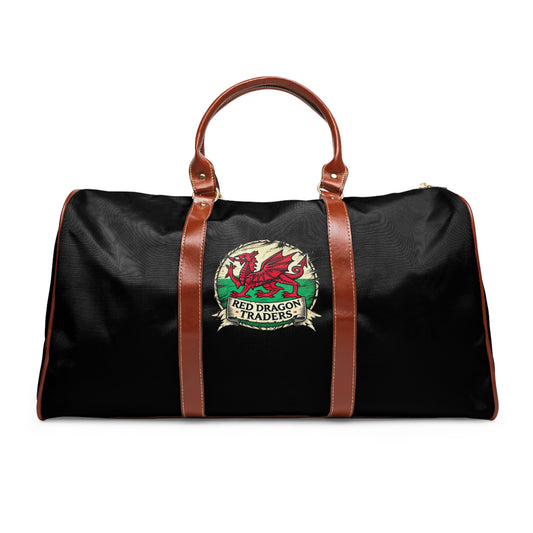 Black duffel bag with brown straps and Red Dragon Traders logo on a white background