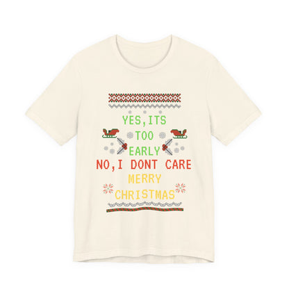 Beige t-shirt with Christmas-themed text and graphics on a white background