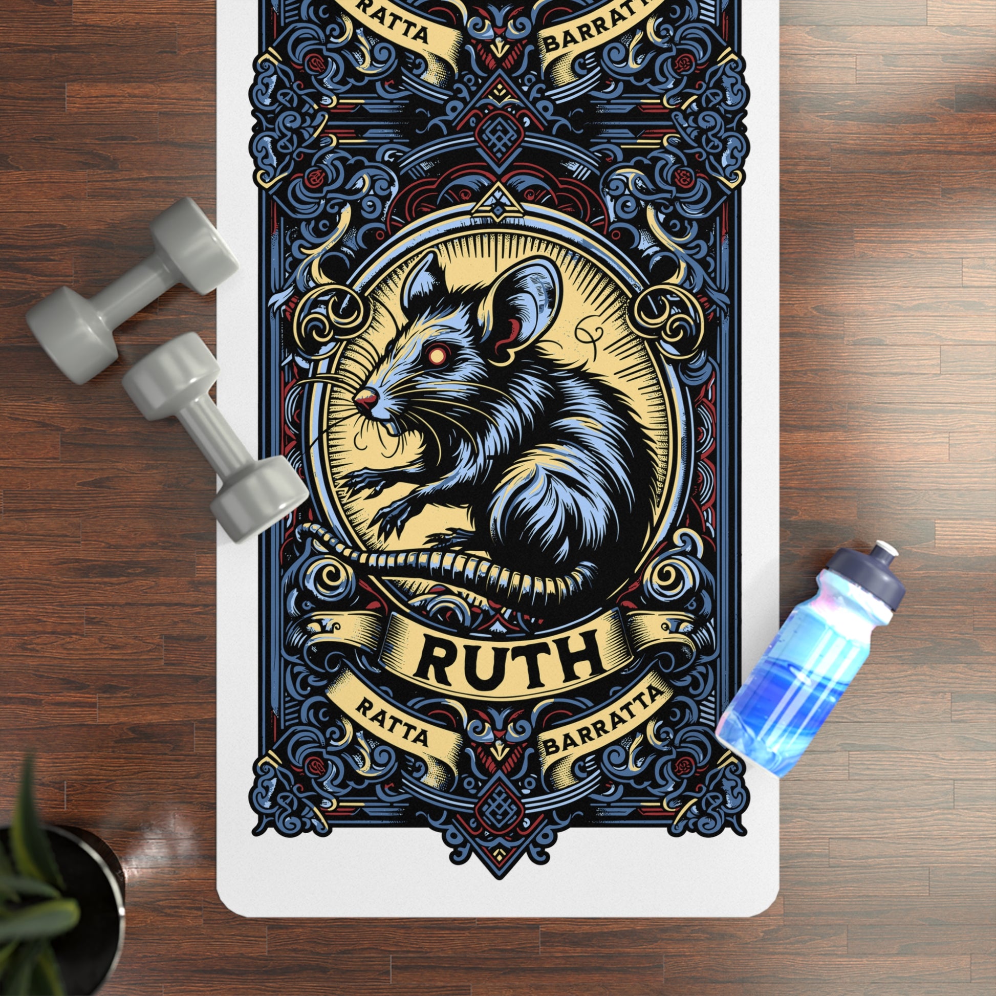 Decorative yoga mat with a rat illustration and 'Ruth' text on a wooden floor with weights and a water bottle.