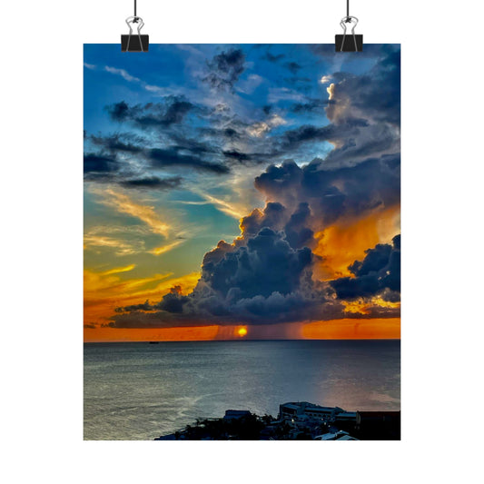 Sunset over water with large clouds and colorful sky