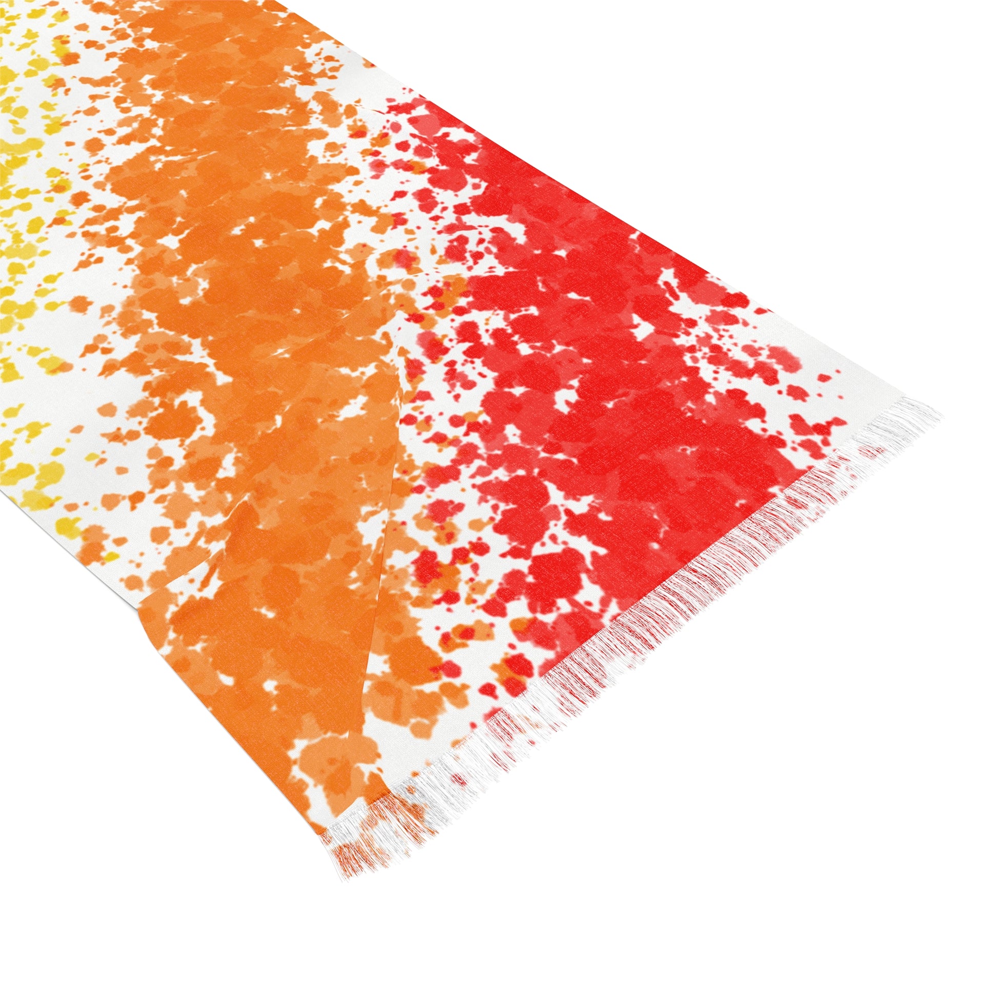 Colorful towel with orange, red, and white pattern on a white background