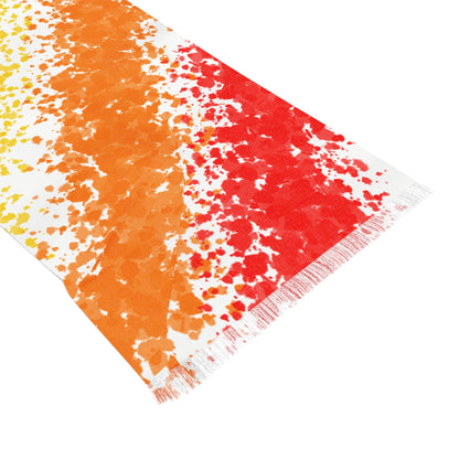 Colorful towel with orange, red, and white pattern on a white background