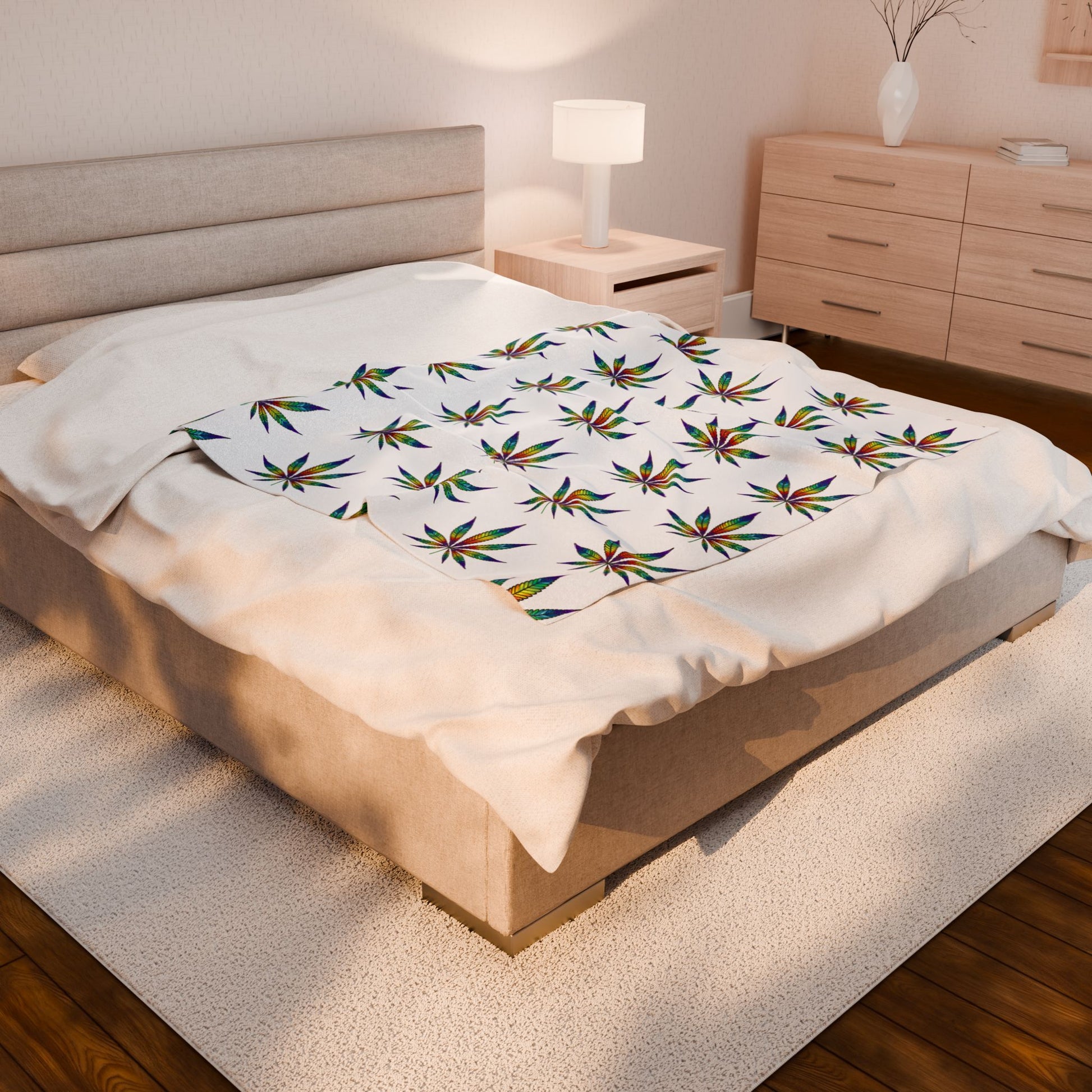 Cannabis Leaf Blanket with rainbow patterns on bed 