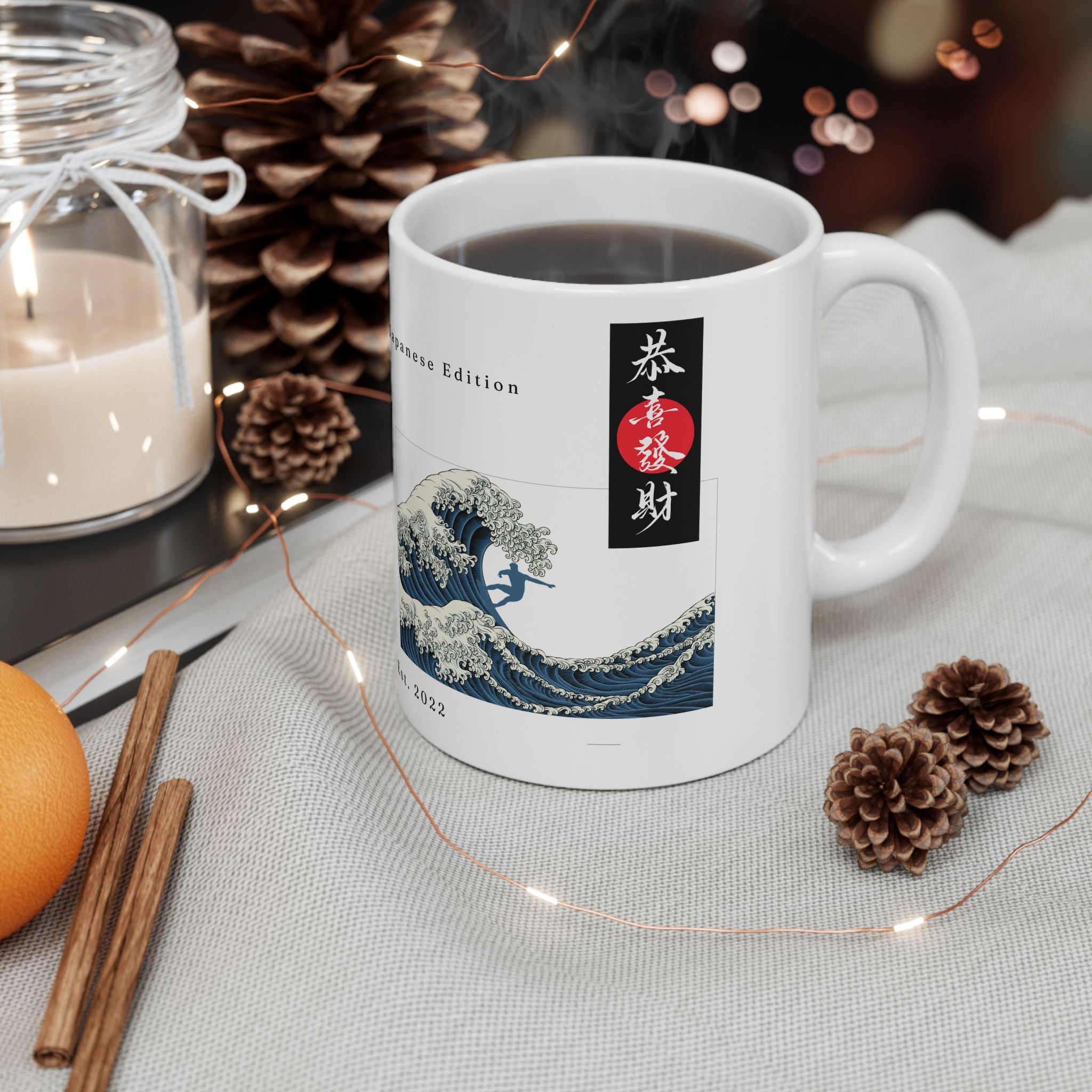 White mug with artistic design and text on a table with decorative items