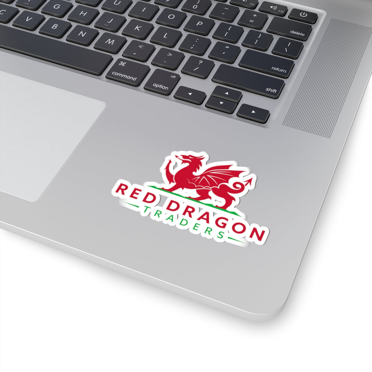 Laptop with a 'Red Dragon Traders' sticker on the palm rest area