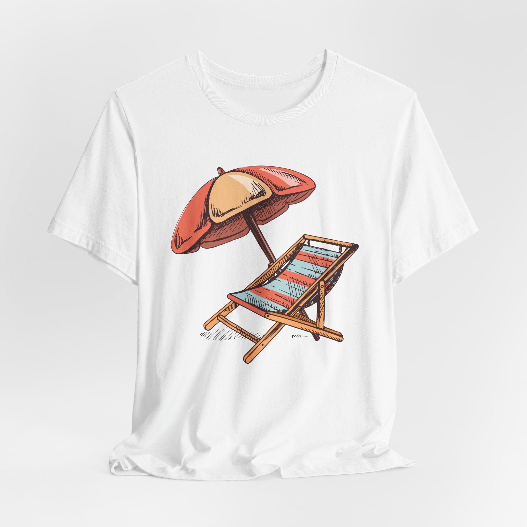 White t-shirt with a sketched beach chair and orange umbrella graphic, front view on a white background