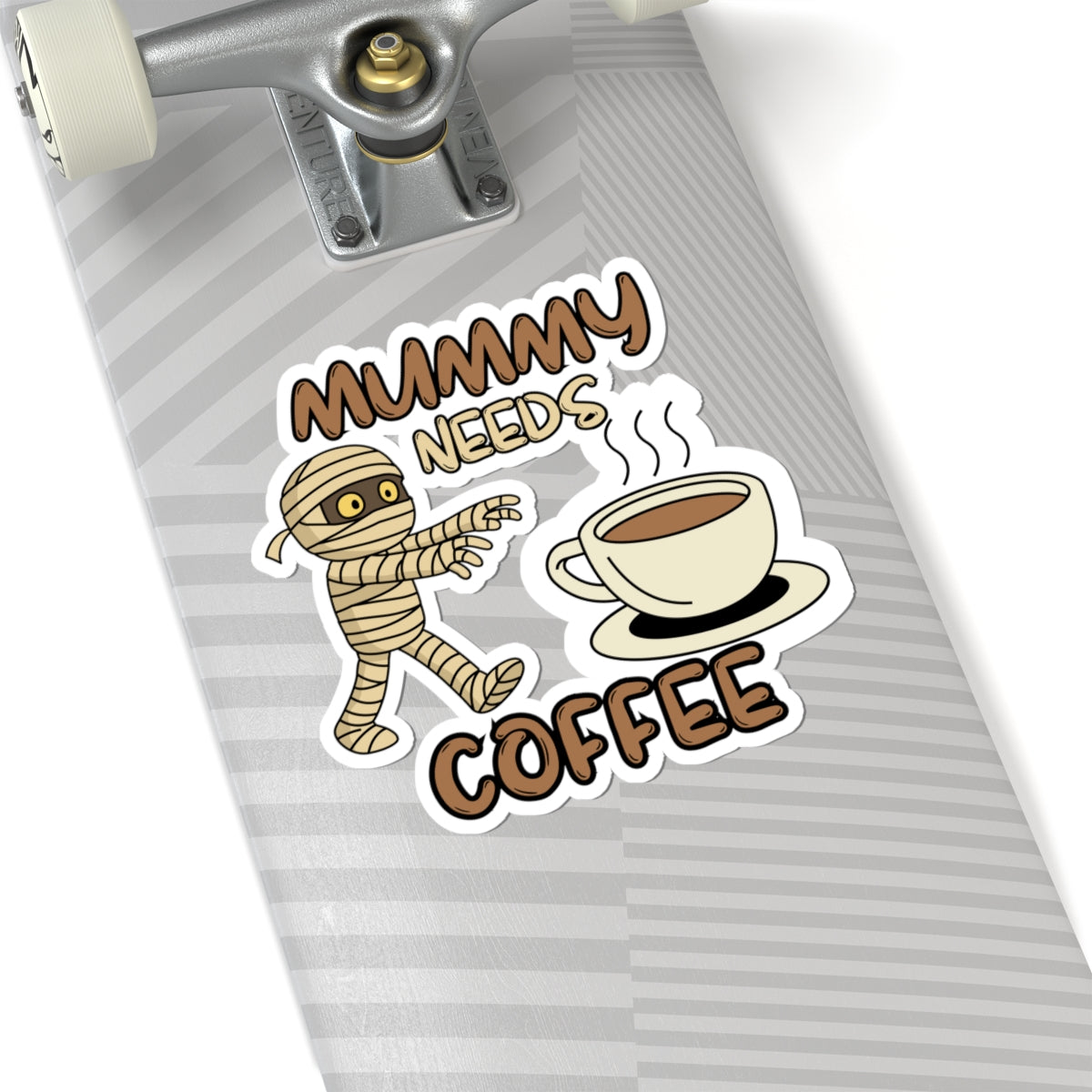 Sticker with a mummy and coffee cup design on a skateboard deck.