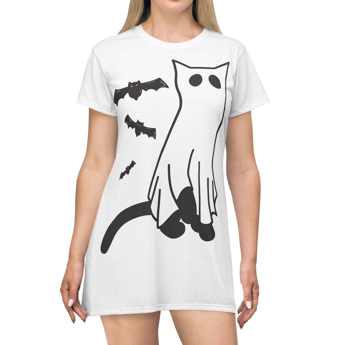 White t-shirt with black cat, bat, and ghost design worn by a person on a white background