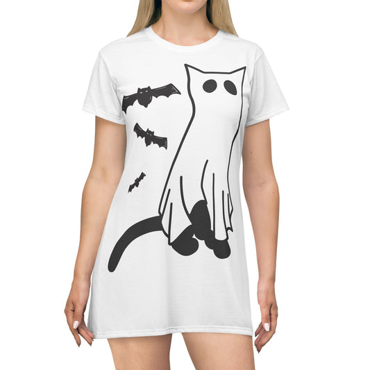 White t-shirt with black cat, bat, and ghost design worn by a person on a white background