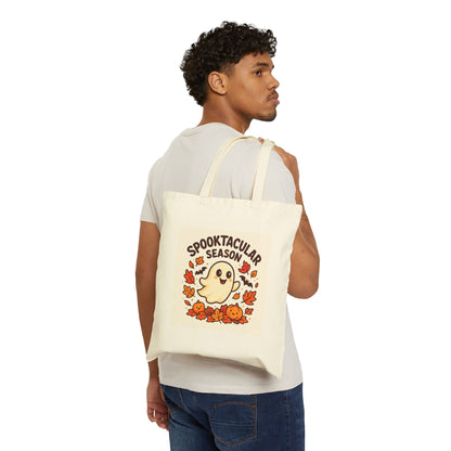 Person holding a tote bag with 'Spooktacular Season' design on a white background
