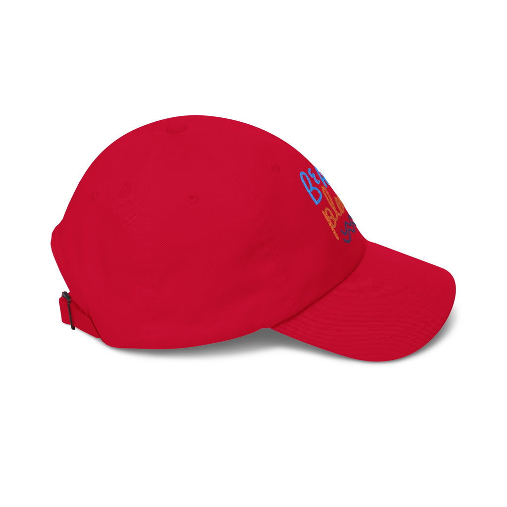 Red dad cap with embroidered 'Beach Please' text, side view on a white background
