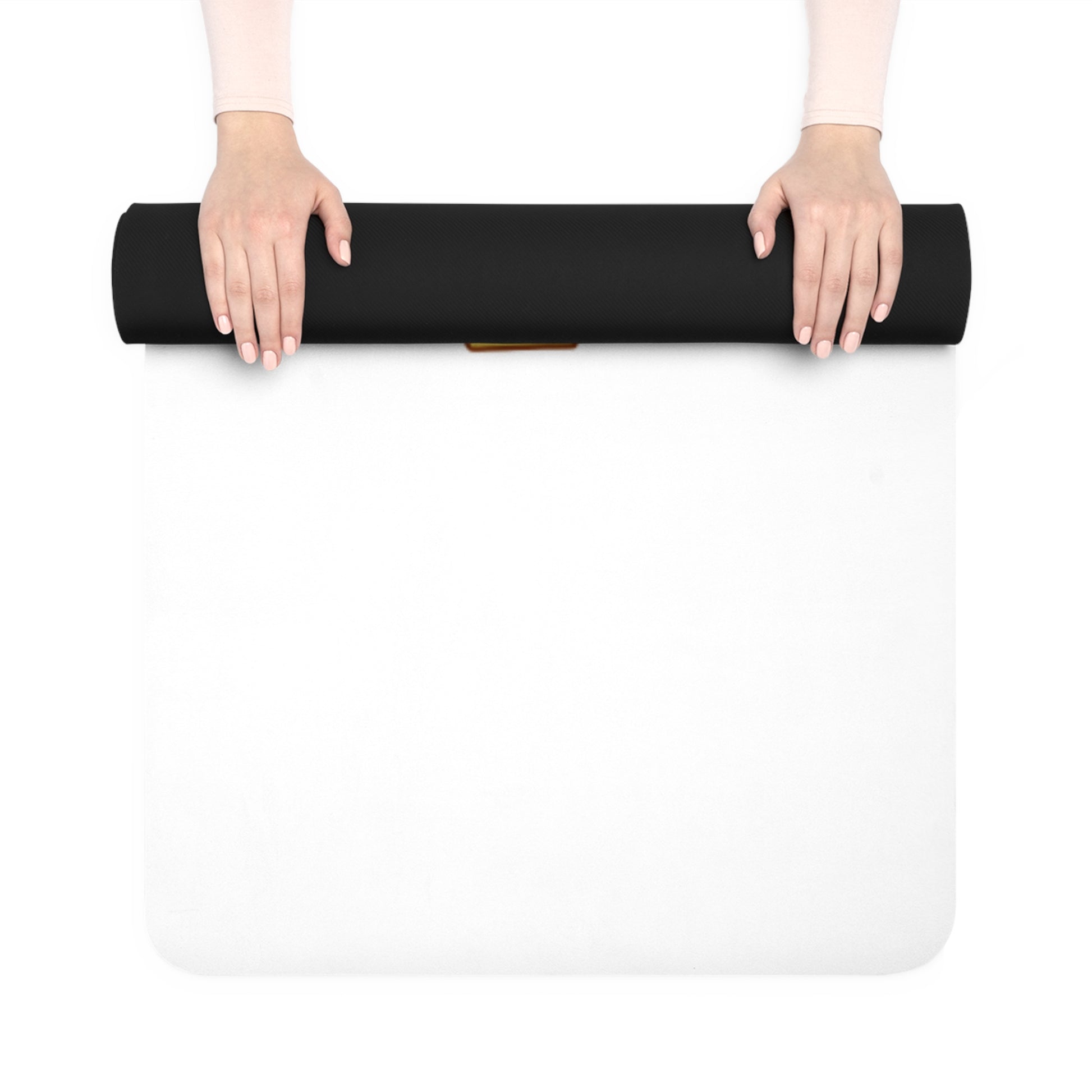 Person holding a black yoga mat over a white surface