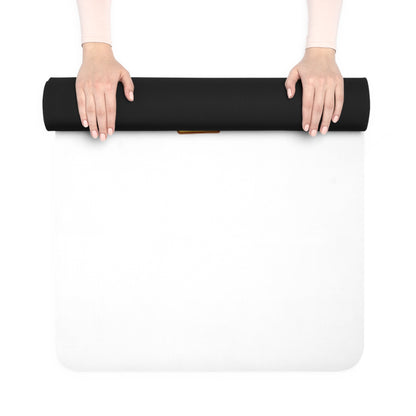 Person holding a black yoga mat over a white surface