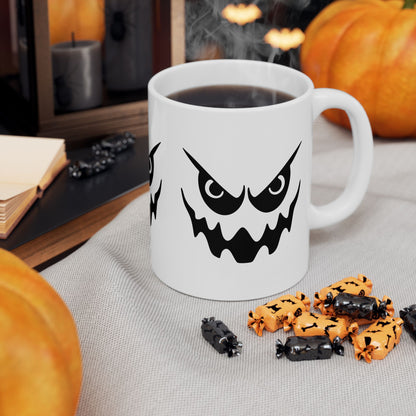 White mug with Halloween-themed design, surrounded by pumpkins and treats on a table.