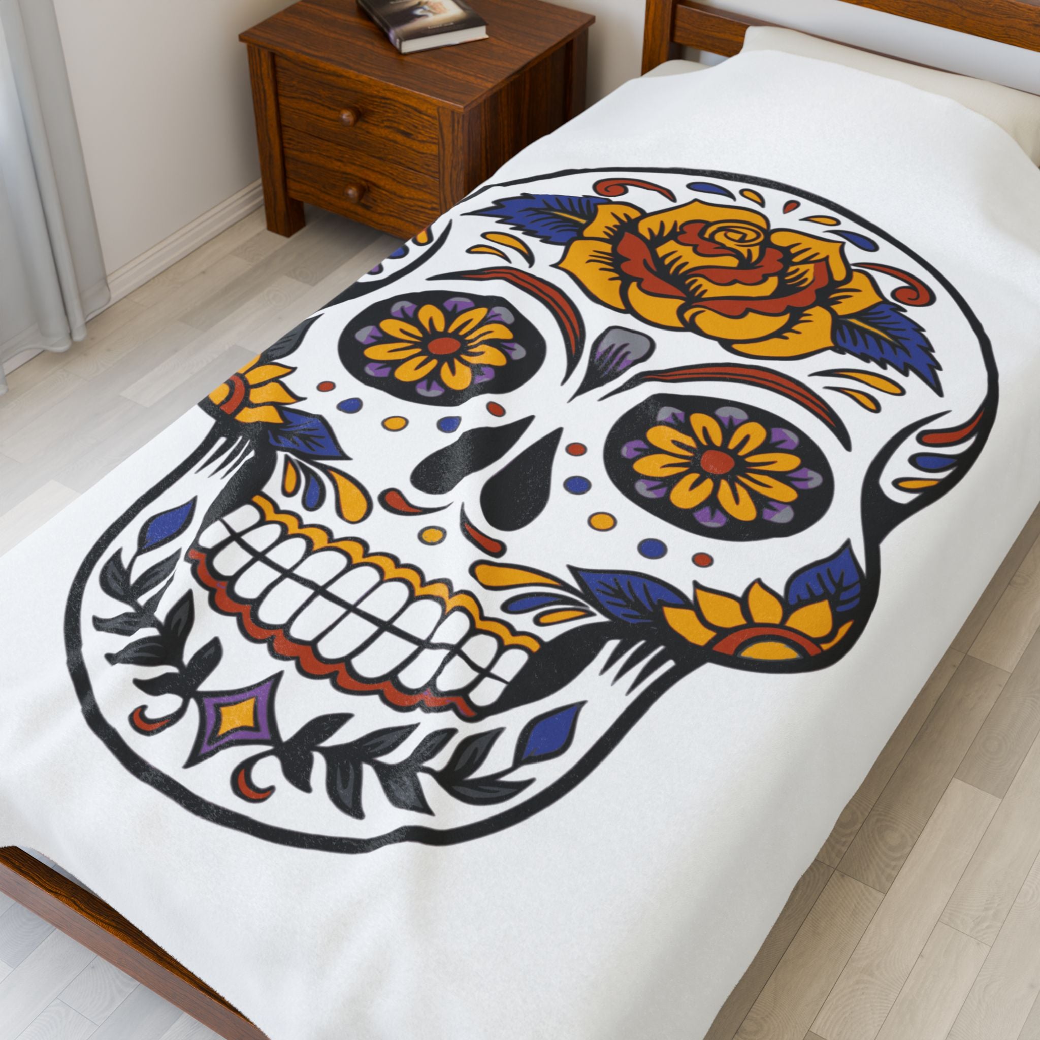 Sugar skull blanket with colorful design on a bedspread in a bedroom setting