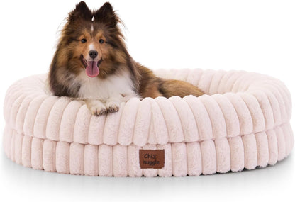 Dog lying on a fluffy pink pet bed with a visible brand logo.