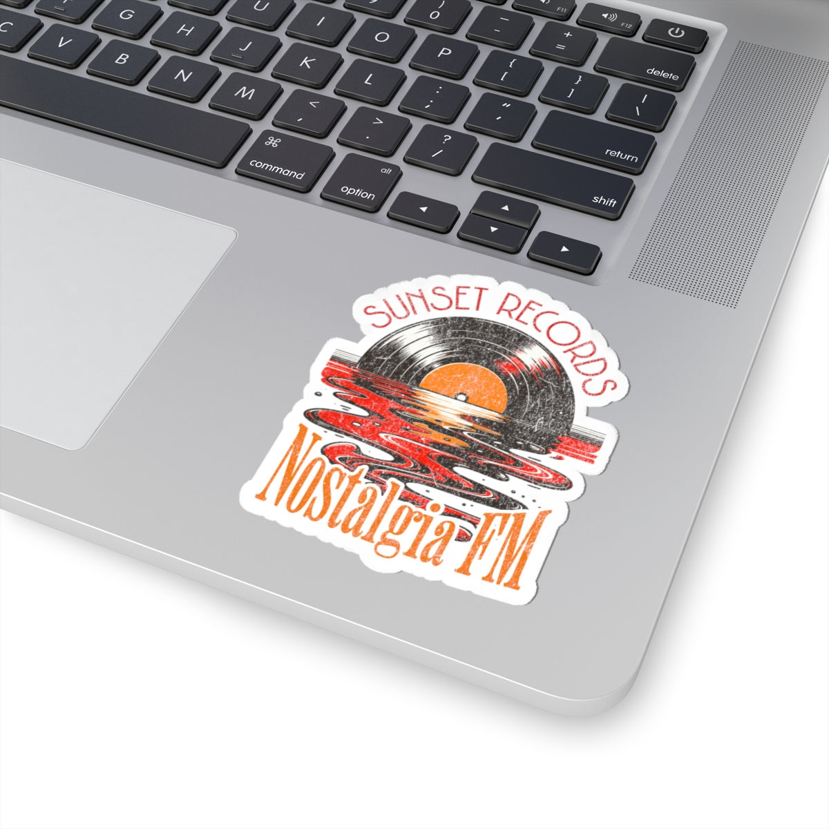 Sticker with 'Sunset Records Nostalgia FM' design on a laptop
