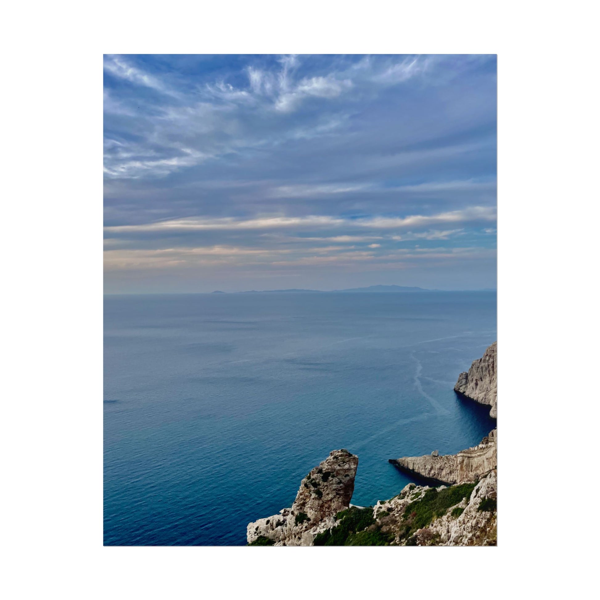 Scenic view of a coastal landscape with cliffs and blue sky.